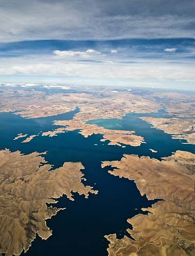 keban dam aerial shot of body of water surrounded by land turkey